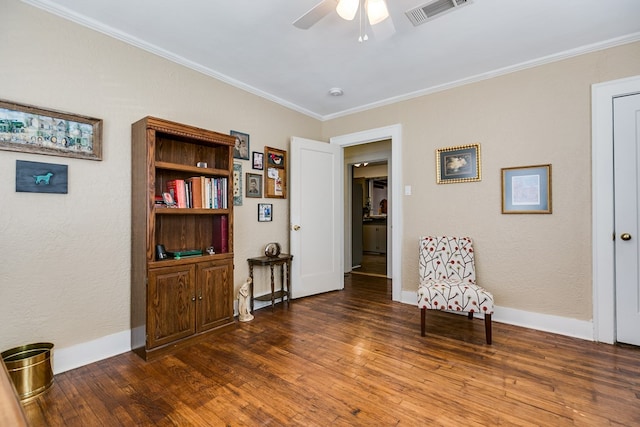 sitting room with ornamental molding, ceiling fan, and dark hardwood / wood-style flooring