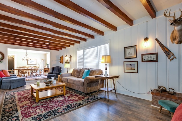 living room featuring beam ceiling, wood-type flooring, and a chandelier