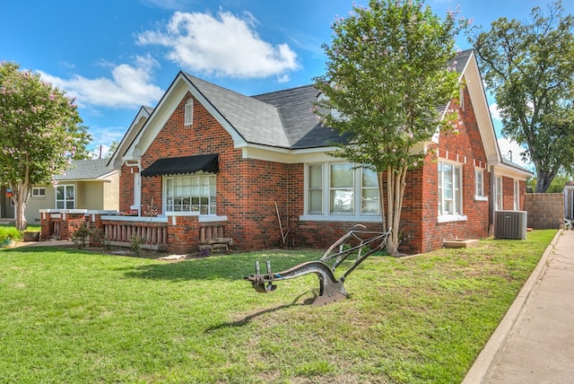 view of front of property featuring a front yard and central air condition unit