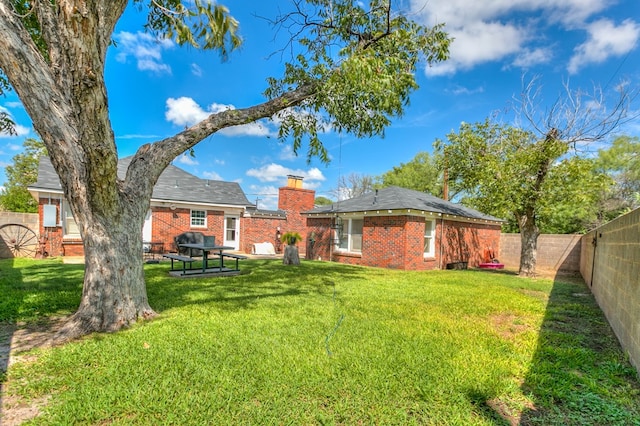 rear view of house with a yard