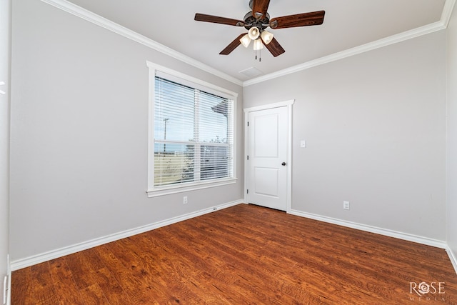 empty room with ornamental molding, hardwood / wood-style floors, and ceiling fan