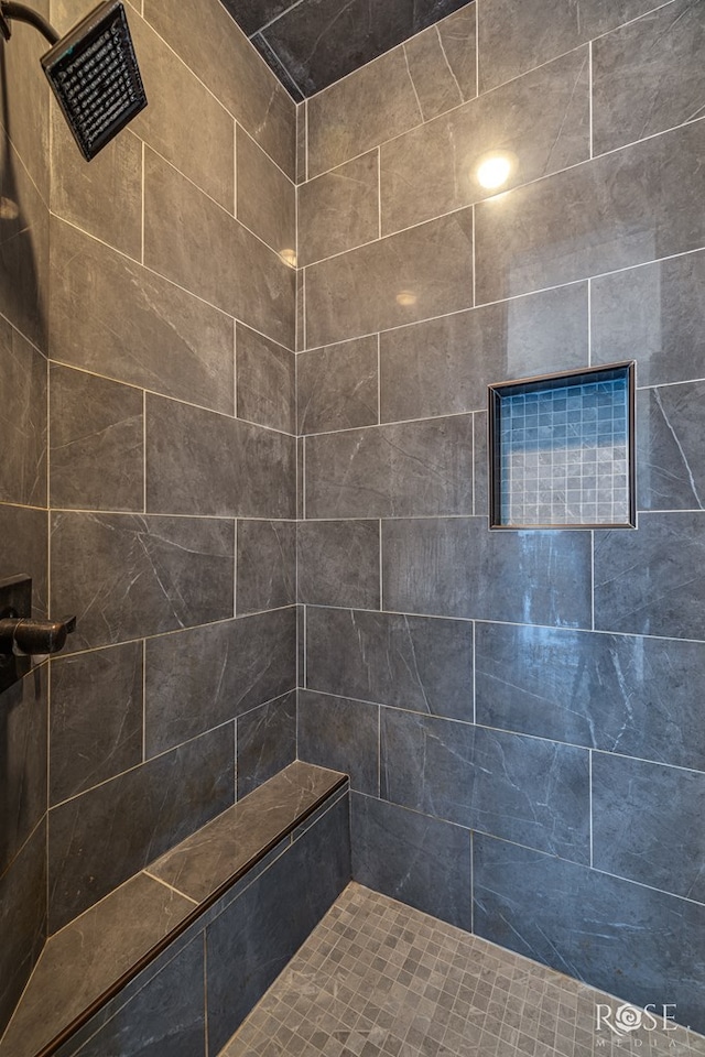 bathroom with a tile shower