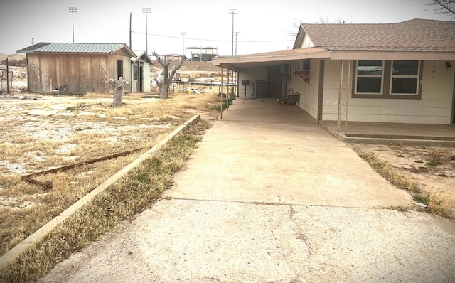 view of side of home with a carport