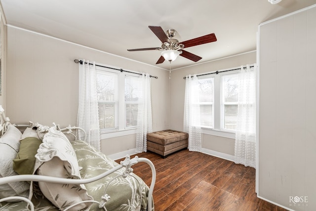 living area with dark wood-style floors, baseboards, and a ceiling fan