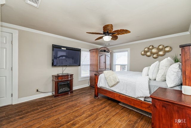 bedroom with baseboards, visible vents, dark wood finished floors, and ornamental molding