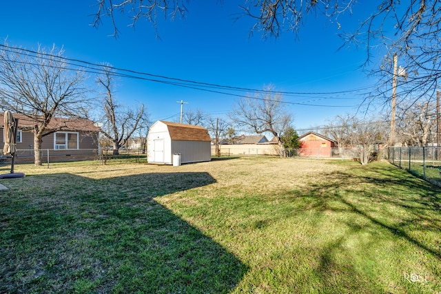 view of yard with a shed, an outdoor structure, and a fenced backyard