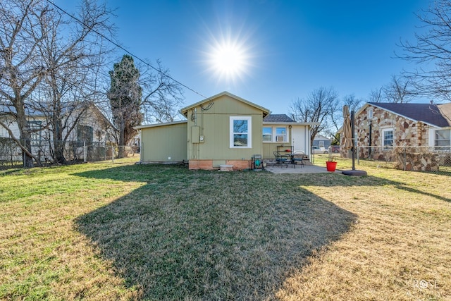 back of property featuring a yard, a patio area, and fence