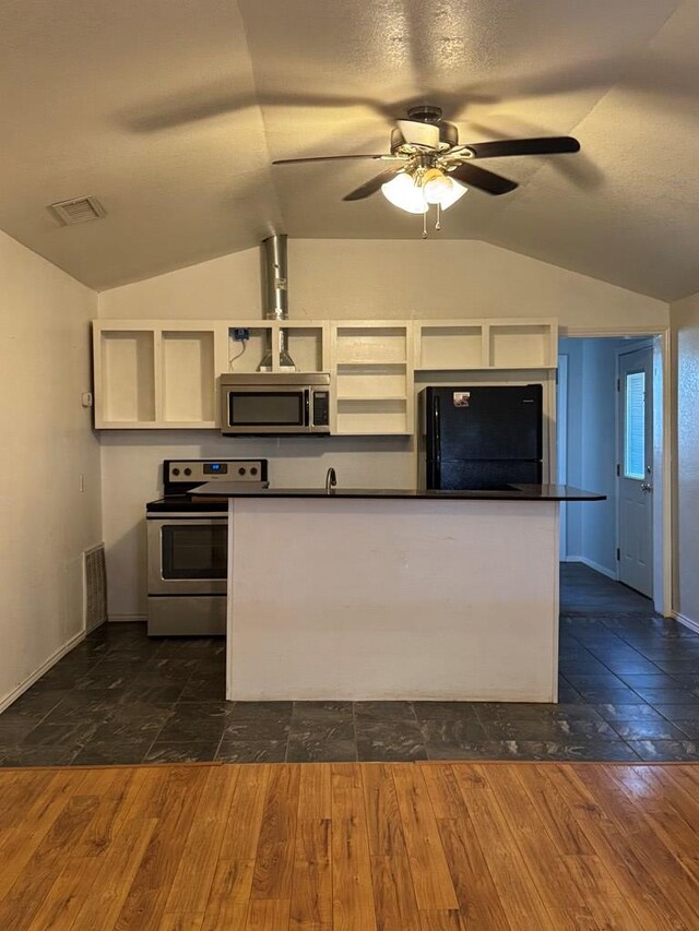 kitchen with ceiling fan, appliances with stainless steel finishes, a textured ceiling, dark hardwood / wood-style flooring, and vaulted ceiling