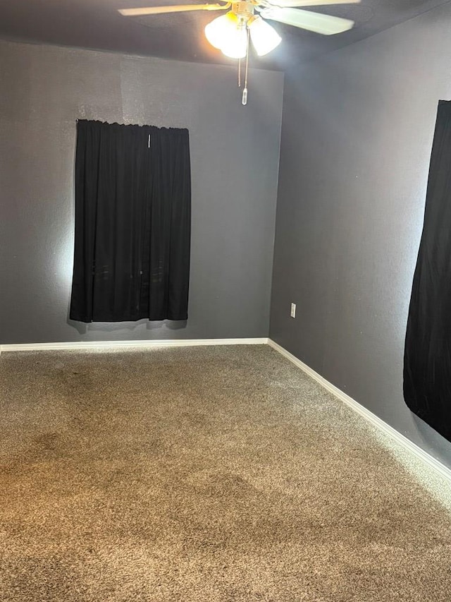 empty room featuring carpet floors and ceiling fan