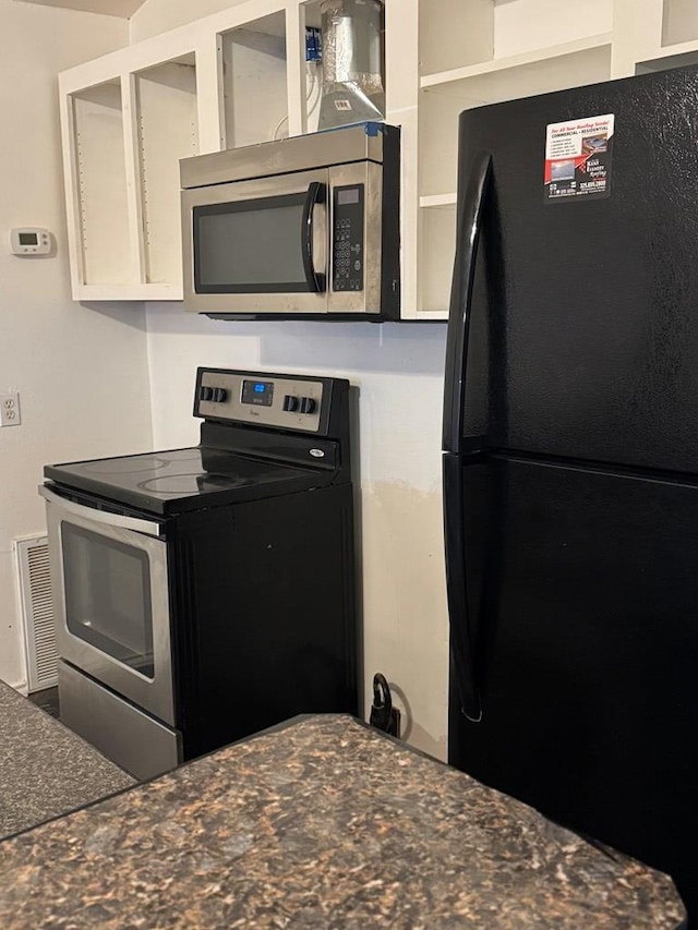 kitchen with stainless steel appliances and white cabinets