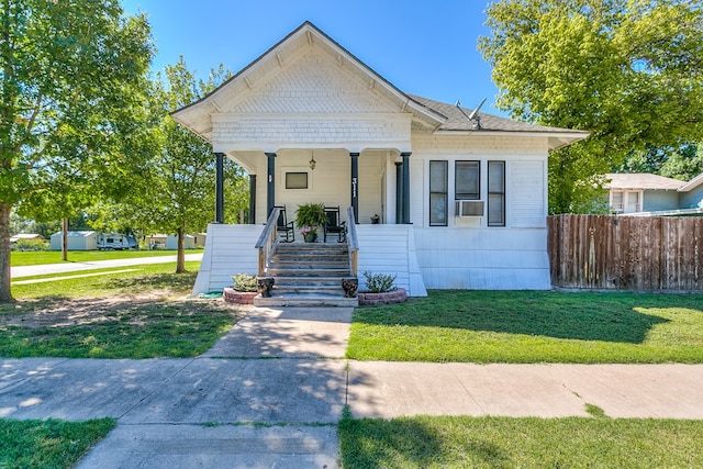 bungalow-style house featuring a front yard and covered porch