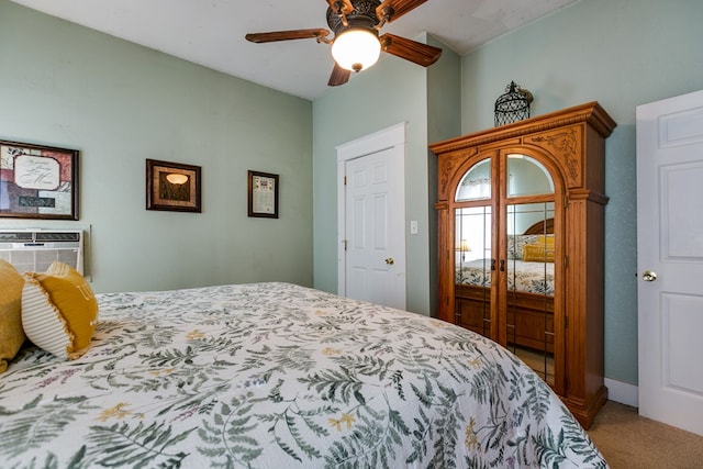 carpeted bedroom with a wall mounted air conditioner, a closet, and ceiling fan