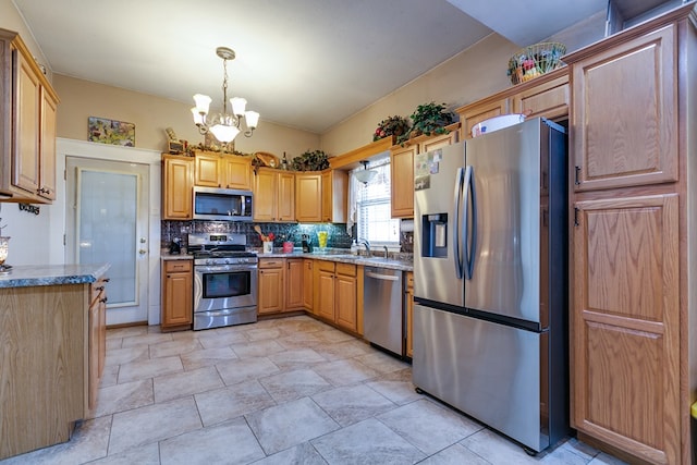 kitchen featuring sink, decorative light fixtures, a notable chandelier, stainless steel appliances, and decorative backsplash