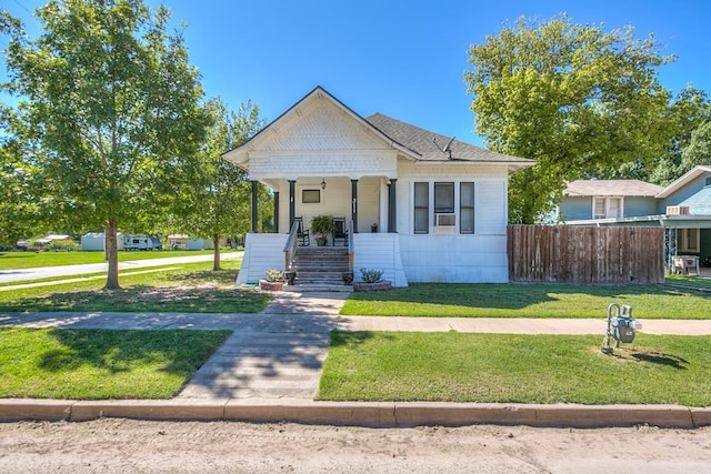 bungalow featuring a front yard and covered porch