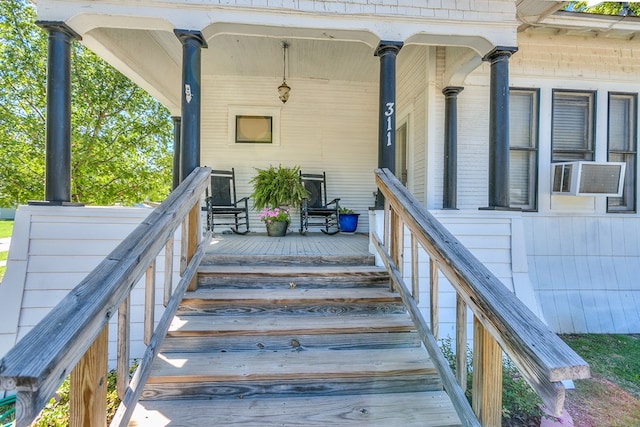 view of exterior entry with cooling unit and a porch