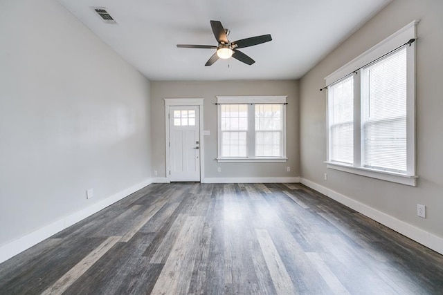 empty room featuring ceiling fan and dark hardwood / wood-style floors