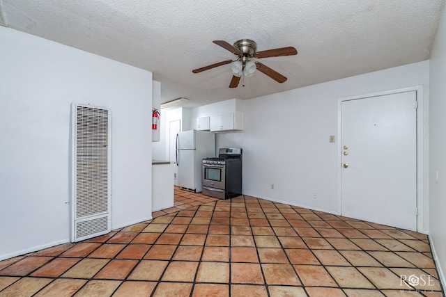 323 E 6th St, San Angelo, TX 76903 - unfurnished living room featuring a heating unit, ceiling fan, and a textured ceiling