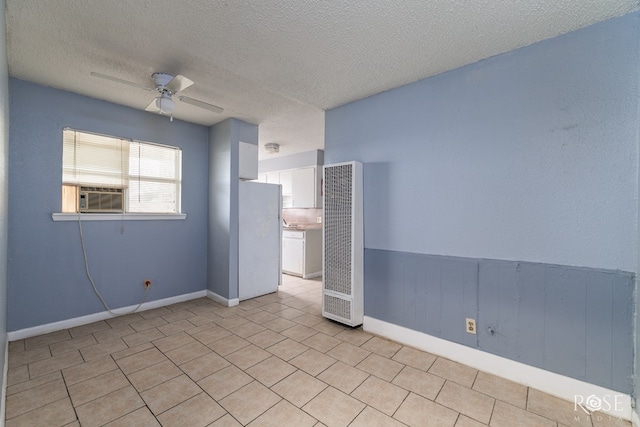 323 E 6th St, San Angelo, TX 76903 - unfurnished room with a heating unit, ceiling fan, a textured ceiling, baseboards, and light tile patterned floors
