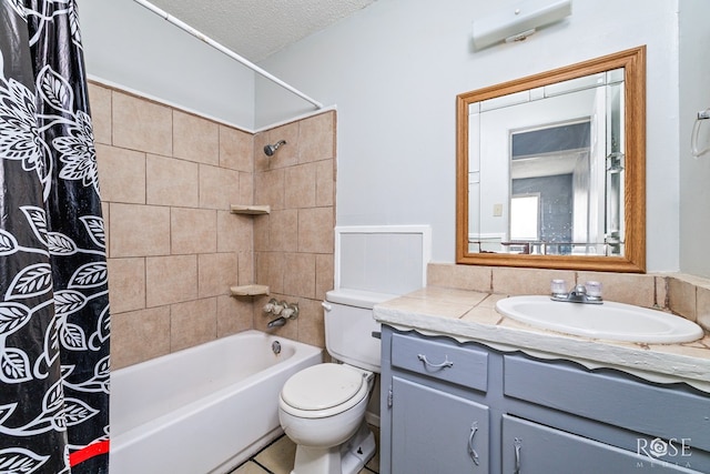 323 E 6th St, San Angelo, TX 76903 - bathroom featuring toilet, shower / tub combo with curtain, vanity, and a textured ceiling