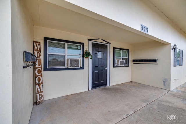 323 E 6th St, San Angelo, TX 76903 - property entrance with stucco siding and cooling unit
