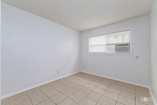 323 E 6th St, San Angelo, TX 76903 - unfurnished room featuring cooling unit, light tile patterned floors, and baseboards