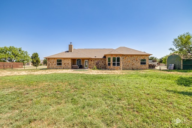 7738 Bison Trl, San Angelo, TX 76901 - back of house with a chimney and stone siding