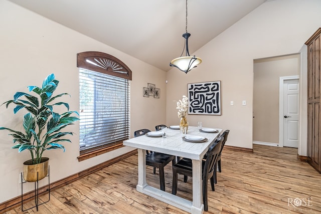 7738 Bison Trl, San Angelo, TX 76901 - dining area featuring light wood finished floors, plenty of natural light, baseboards, and high vaulted ceiling
