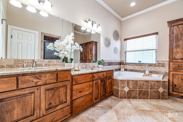 7738 Bison Trl, San Angelo, TX 76901 - bathroom with double vanity, a garden tub, ornamental molding, a stall shower, and tile patterned floors