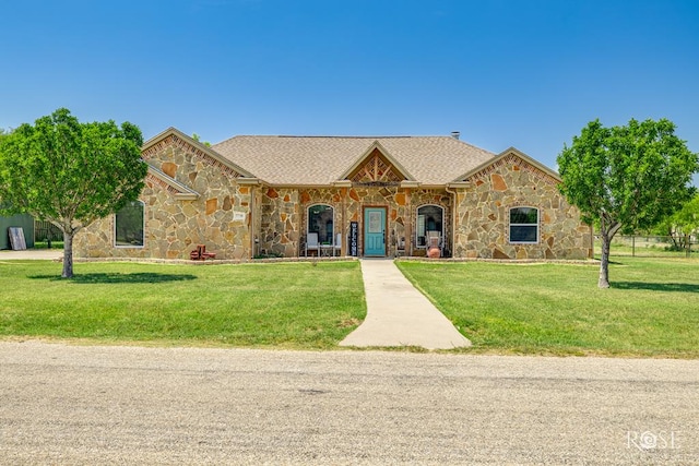 7738 Bison Trl, San Angelo, TX 76901 - view of front of property with stone siding, a front lawn, and a shingled roof