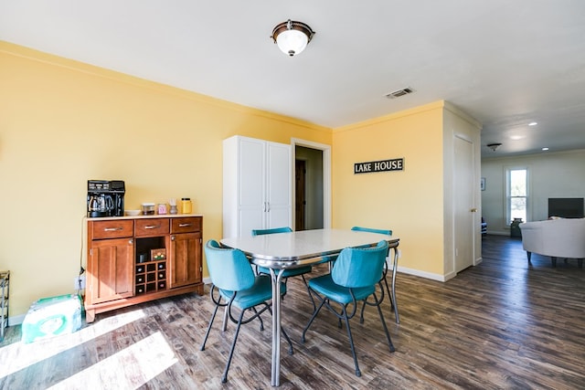 dining area featuring visible vents, baseboards, and dark wood-style flooring