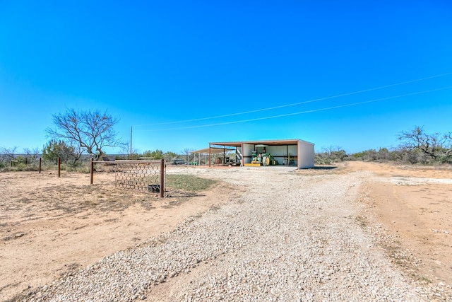 exterior space featuring driveway and a pole building