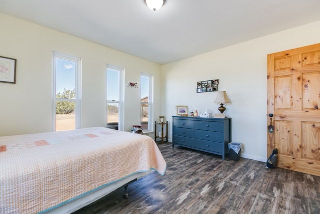 bedroom featuring dark wood finished floors and baseboards