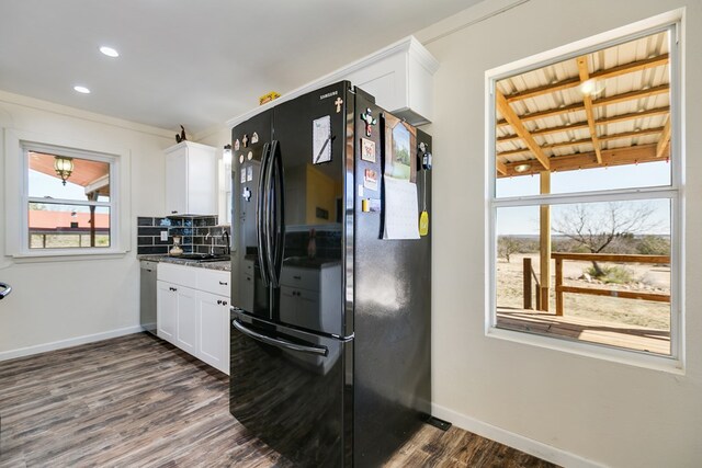 kitchen featuring baseboards, dark wood-style flooring, freestanding refrigerator, white cabinetry, and tasteful backsplash