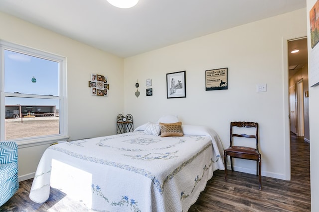 bedroom featuring baseboards and dark wood-style floors