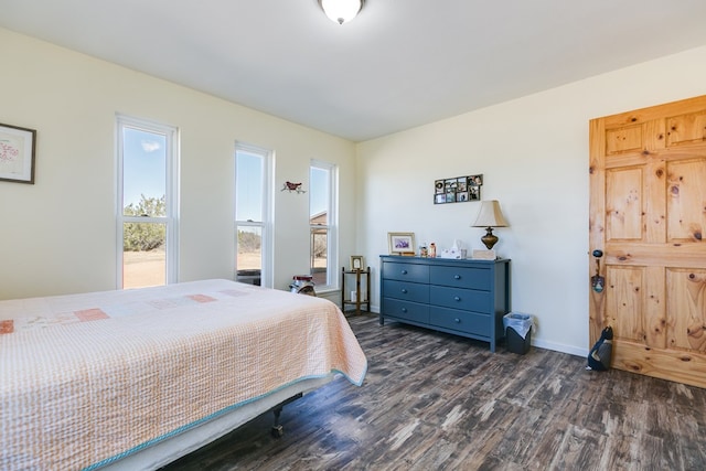 bedroom with baseboards and dark wood-style floors