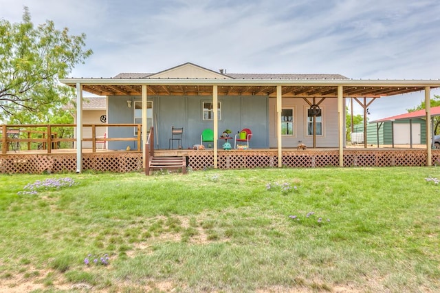 rear view of property featuring a lawn