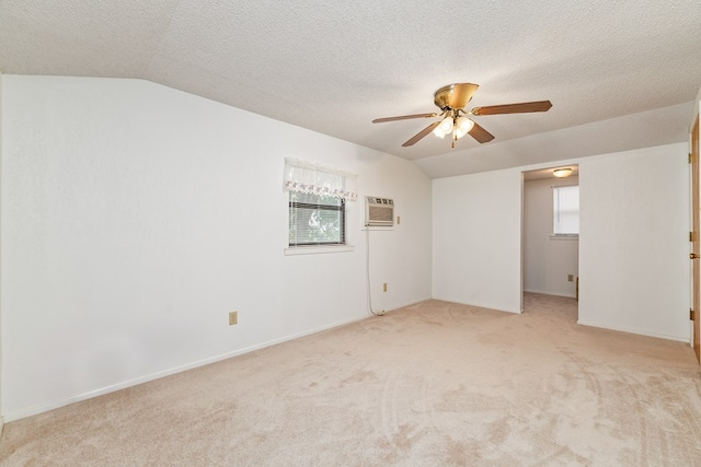 8881 Rust Rd, San Angelo, TX 76905 - unfurnished room with light carpet, ceiling fan, lofted ceiling, plenty of natural light, and an AC wall unit