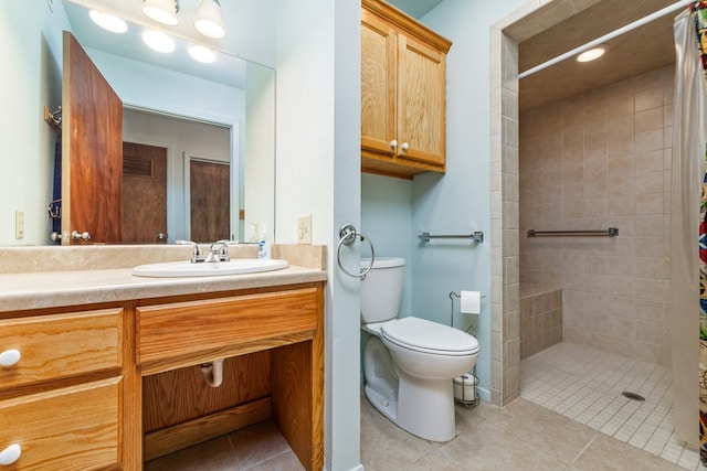 8881 Rust Rd, San Angelo, TX 76905 - full bath featuring toilet, tiled shower, vanity, and tile patterned flooring