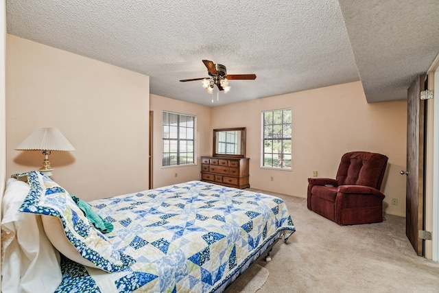 8881 Rust Rd, San Angelo, TX 76905 - bedroom with carpet flooring, a textured ceiling, and a ceiling fan