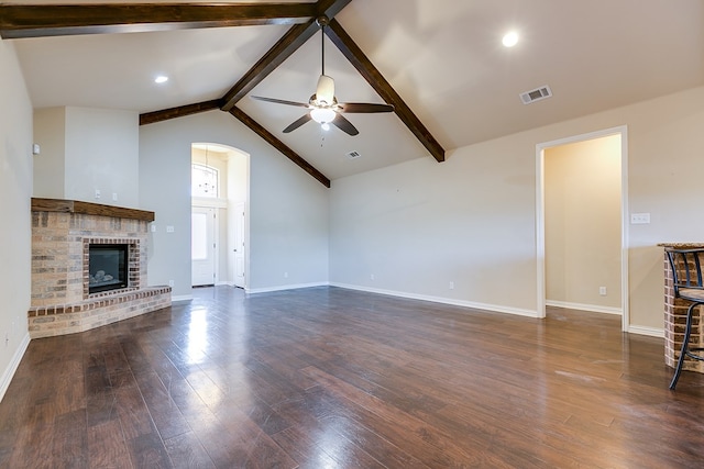 unfurnished living room featuring ceiling fan, visible vents, baseboards, dark wood-style floors, and beamed ceiling