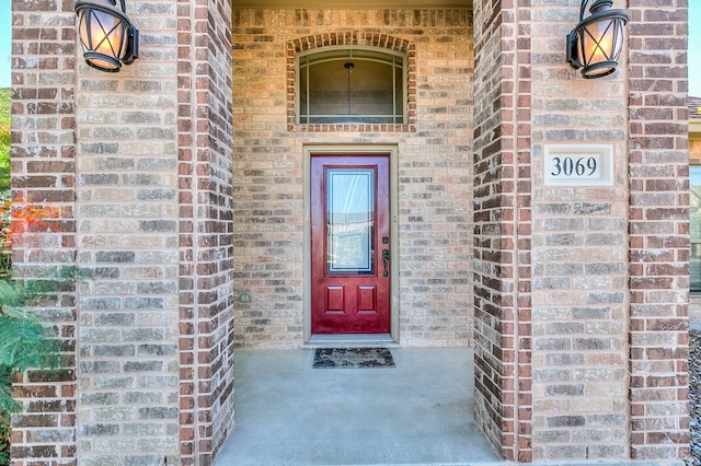 doorway to property with brick siding