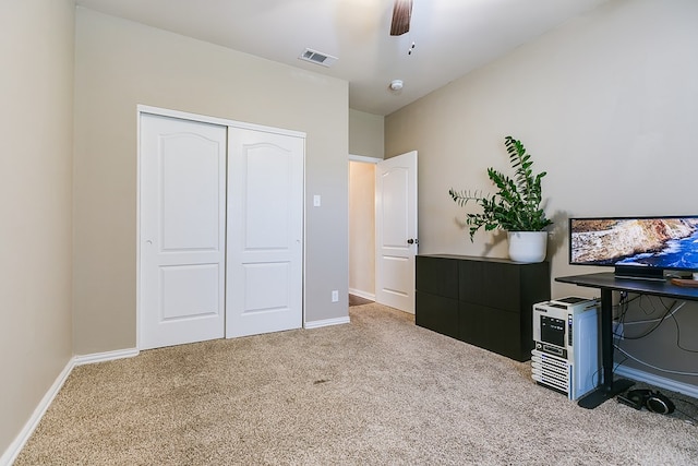 bedroom with ceiling fan, visible vents, baseboards, a closet, and carpet