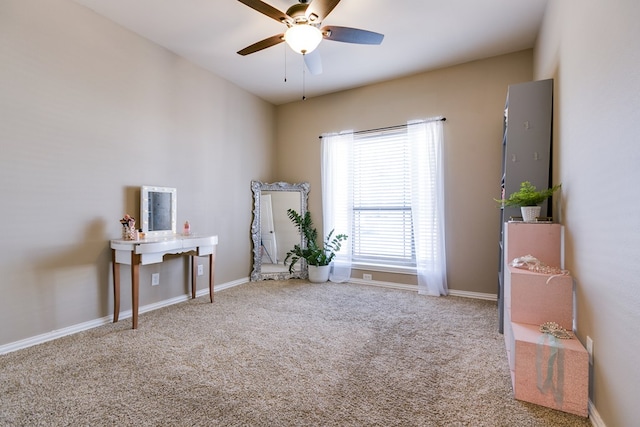 misc room with carpet floors, a ceiling fan, and baseboards