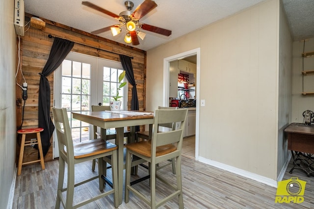 113 N Belaire Ave, San Angelo, TX 76905 - dining room with a textured ceiling, french doors, light wood-type flooring, and ceiling fan