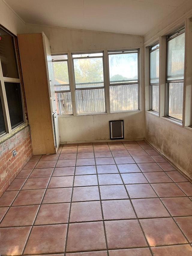 unfurnished sunroom featuring vaulted ceiling