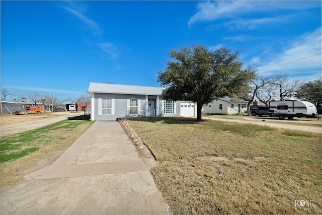 1920 Shady Point Circle Dr, San Angelo, TX 76904 - ranch-style home with metal roof, a front yard, driveway, and stucco siding