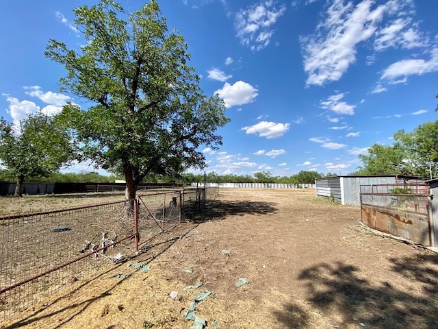 view of yard with an outbuilding and a rural view