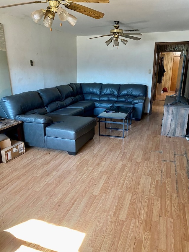 living room with ceiling fan and light hardwood / wood-style flooring