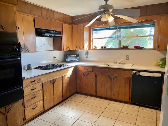 kitchen featuring sink, light tile patterned floors, black dishwasher, gas stovetop, and oven