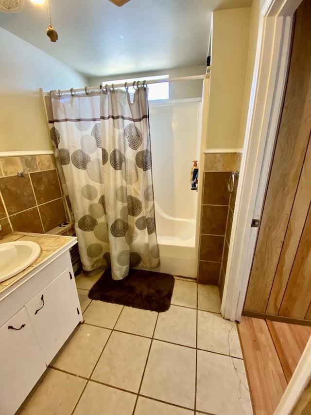 bathroom featuring vanity, tile walls, shower / bath combination with curtain, and tile patterned floors